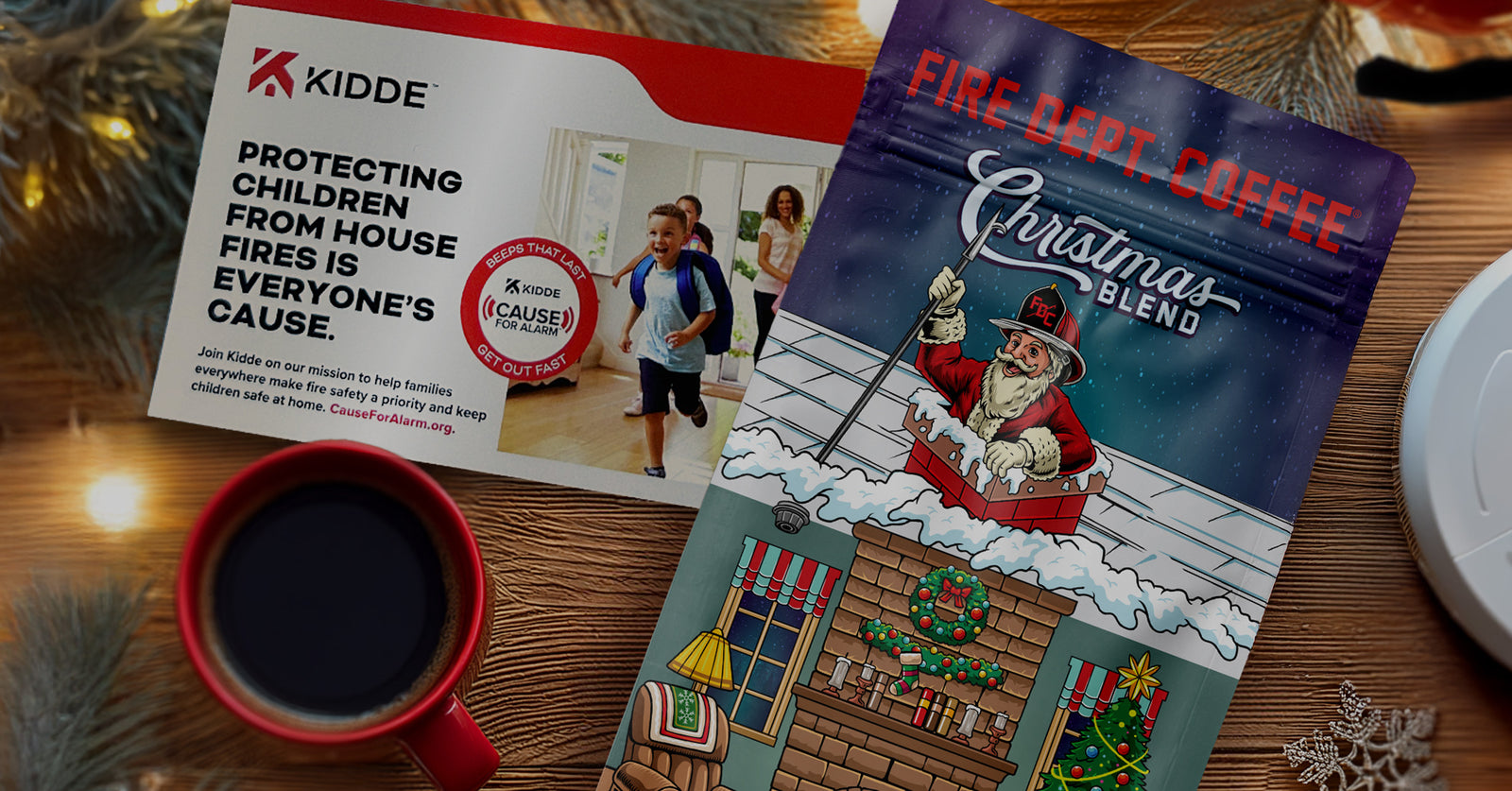 A view from above of a coffee bag with a fire safety card, a cup of coffee and holiday decorations.