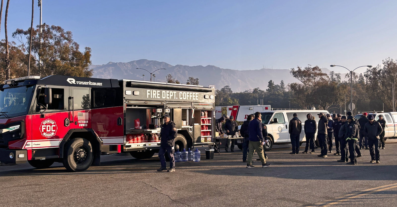 The Fire Department Coffee Firetruck in California as crew members hand out coffee to firefighters.