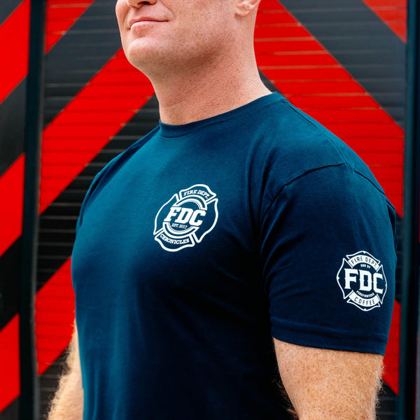 Back of navy shirt with large Fire Dept. Chronicles logo in white.