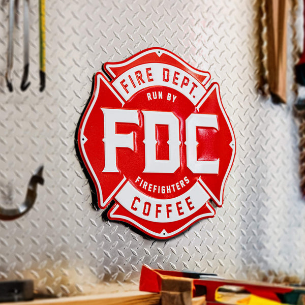 Metal sign of the red Fire Department Coffee Maltese cross logo