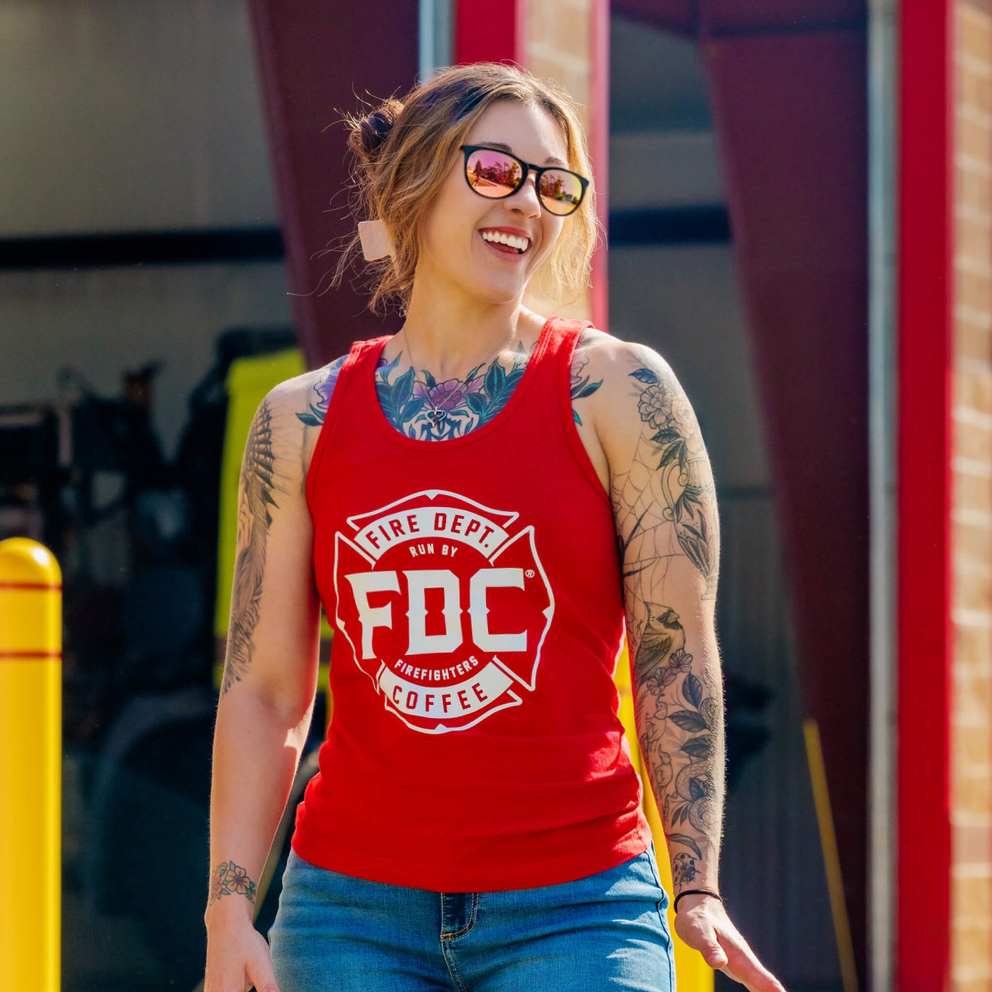 The Fire Department Coffee Red Tank Top featuring a white FDC maltese cross on a red garment.