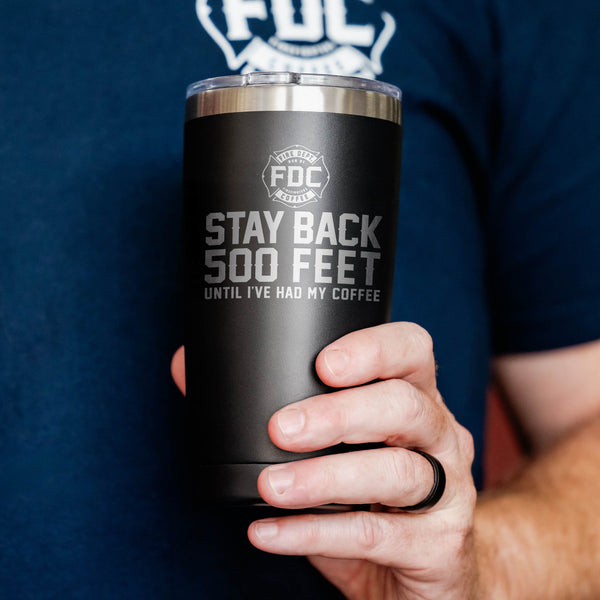 A 20 oz black tumbler that reads STAY BACK 500 FEET UNTIL I'VE HAD MY COFFEE