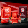 The Coffee Lovers Valentine's Day Bundle, containing a bag of Original Medium Roast, a bag of Black Cherry Bourbon Infused Coffee, a set of Love Coffee Stickers, and a Fire Hydrant mug.