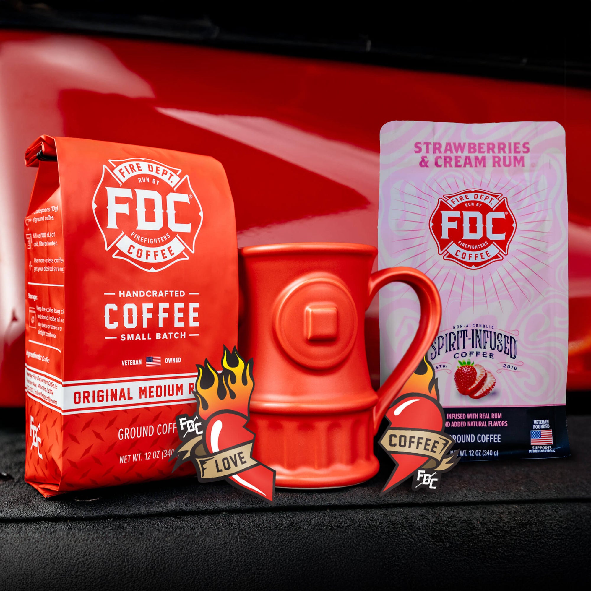 The Coffee Lover Valentine's Bundle, containing a bag of Original Medium Roast, Strawberries and Cream Rum Infused Coffee, a set of Love Coffee Stickers, and a Fire Hydrant mug.