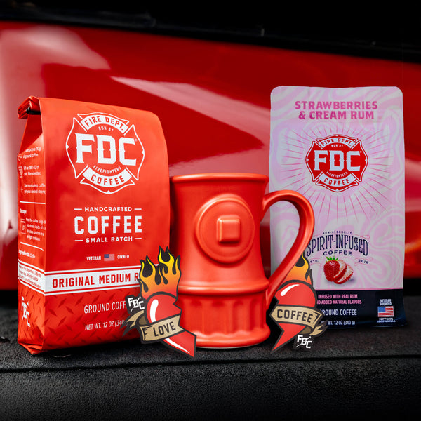 The Coffee Lover Valentine's Bundle, containing a bag of Original Medium Roast, Strawberries and Cream Rum Infused Coffee, a set of Love Coffee Stickers, and a Fire Hydrant mug.