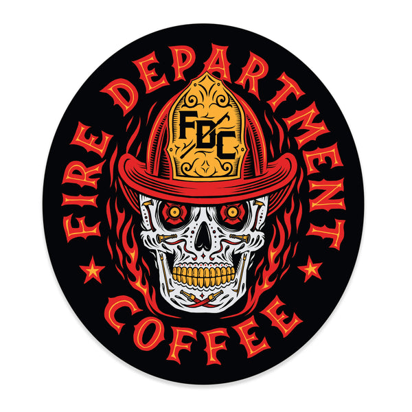 Sticker with a skull wearing an FDC fire helmet surrounded by flames in the center. Around the skull is text that reads "Fire Department Coffee".